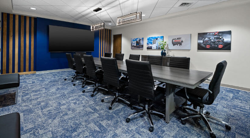 Conference room with wood trim on blue wall