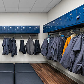 Locker room with blue lockers and seating